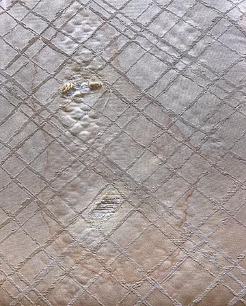 fabric torn by and stained by leaking pen